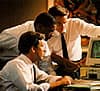 Two colleagues working together over paperwork at a desk